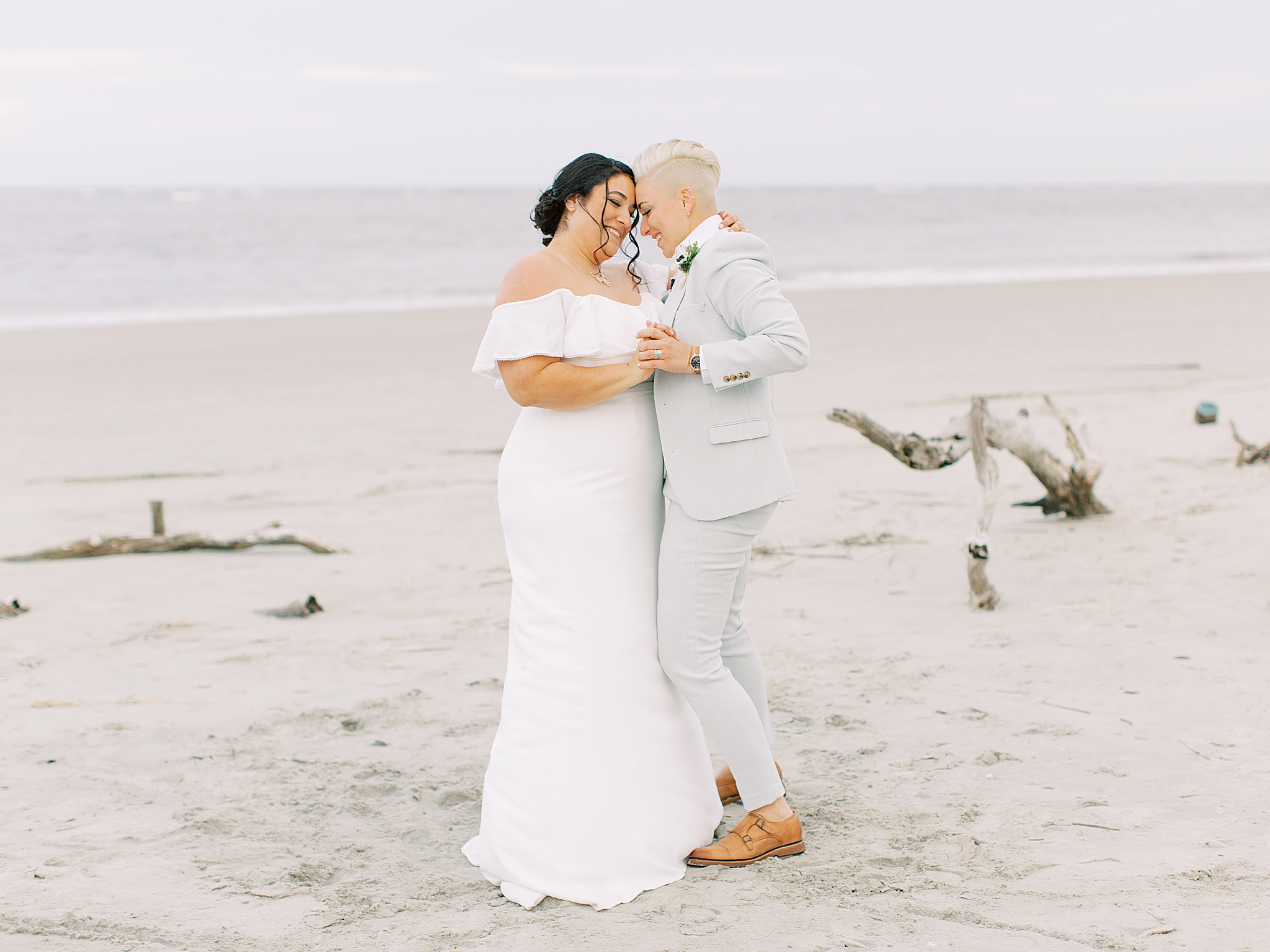 couple dances on sand during Charleston Microwedding on the beach