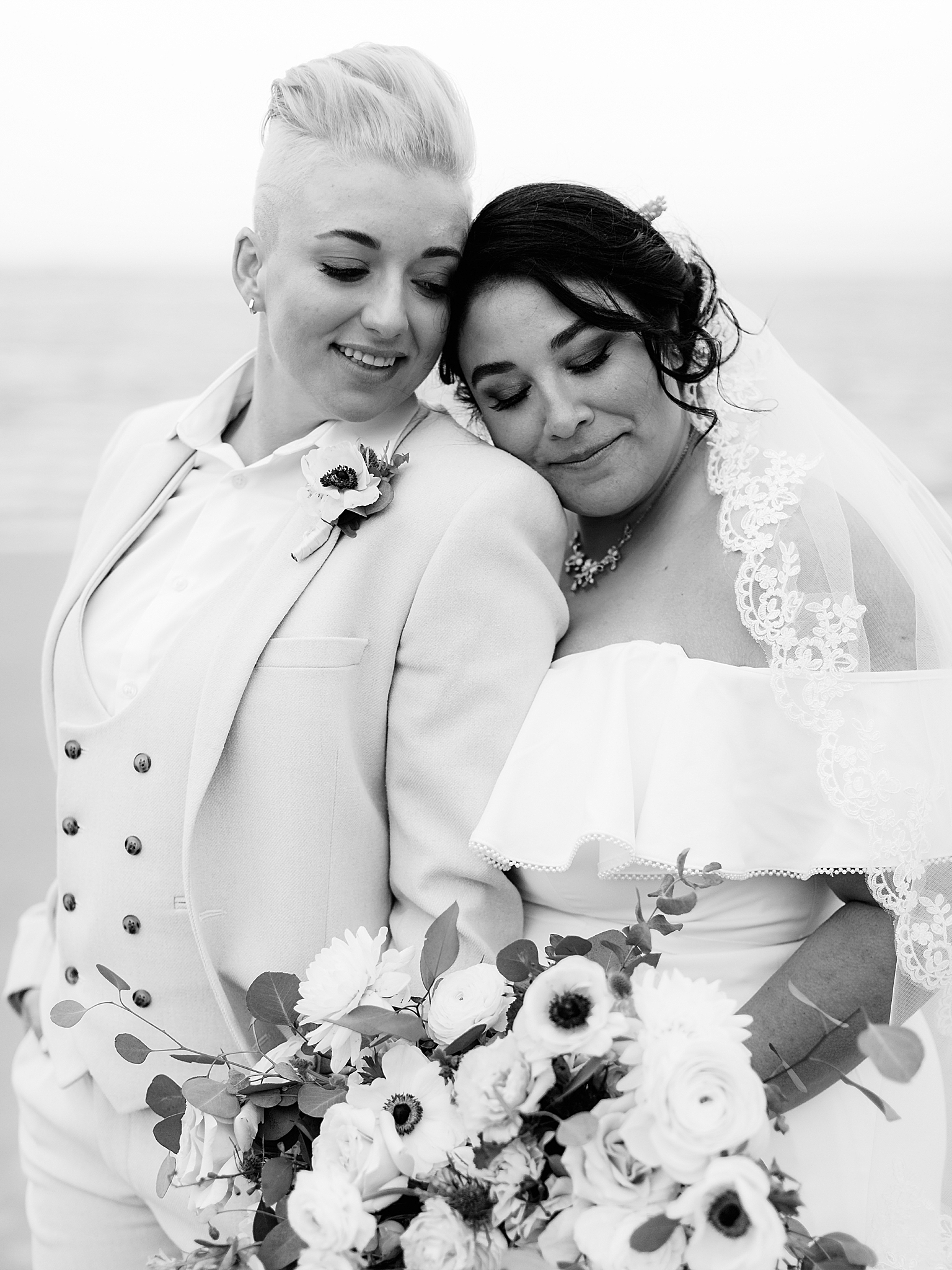 bride leans on partner's shoulder during Charleston Microwedding on the beach
