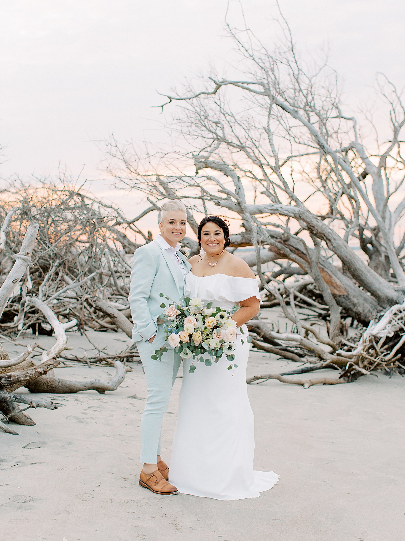 South Carolina newlyweds pose in front of driftwood