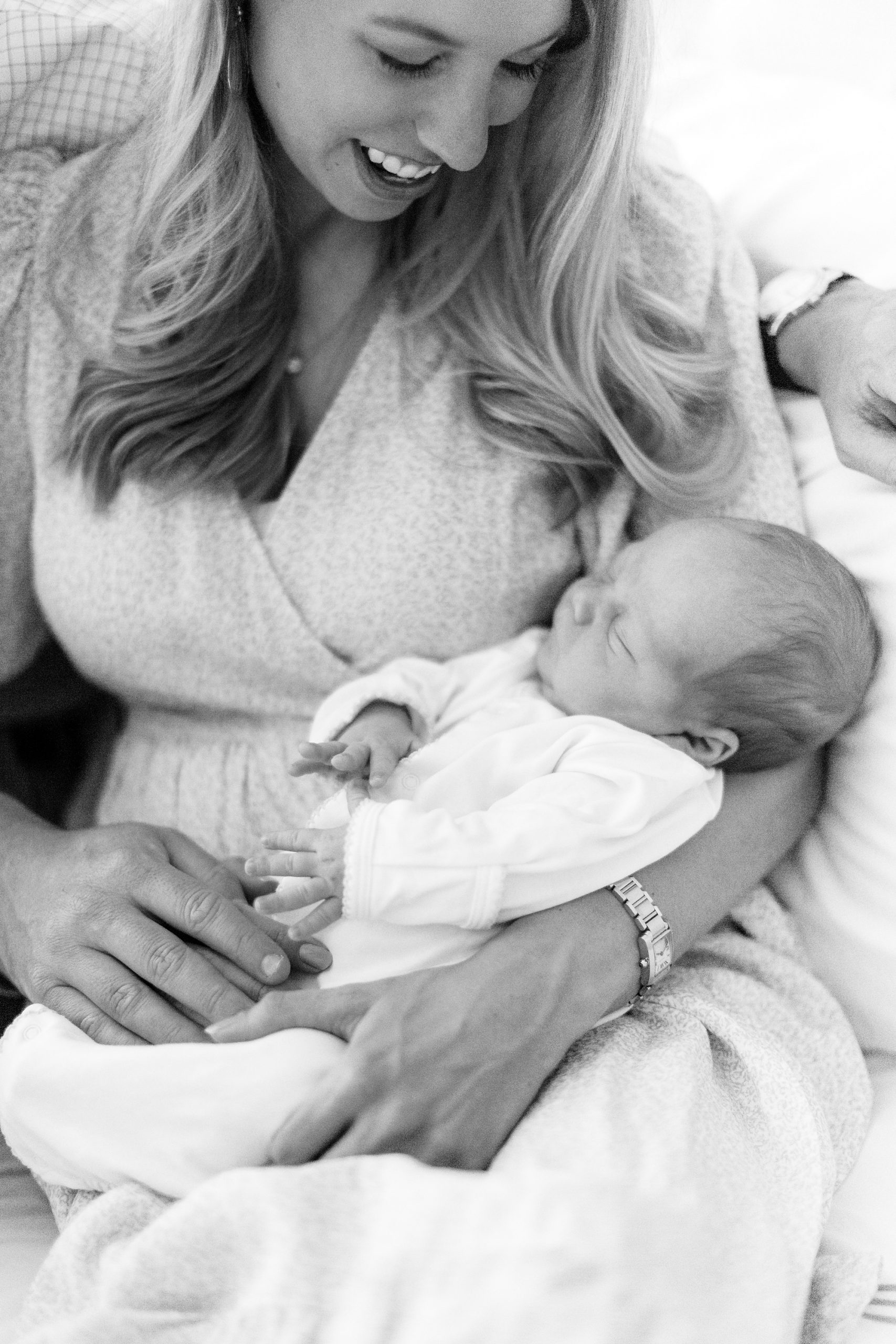 mom holds newborn baby boy in arms during Charlotte lifestyle newborn session