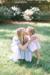 mom kisses daughter during lifestyle photos at home