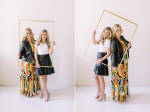 wedding planners pose with gold frame