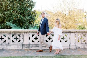 Charlotte NC engagement photos along stone wall in Midtown Park
