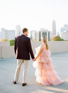 bride and groom walk on Uptown Charlotte rooftop