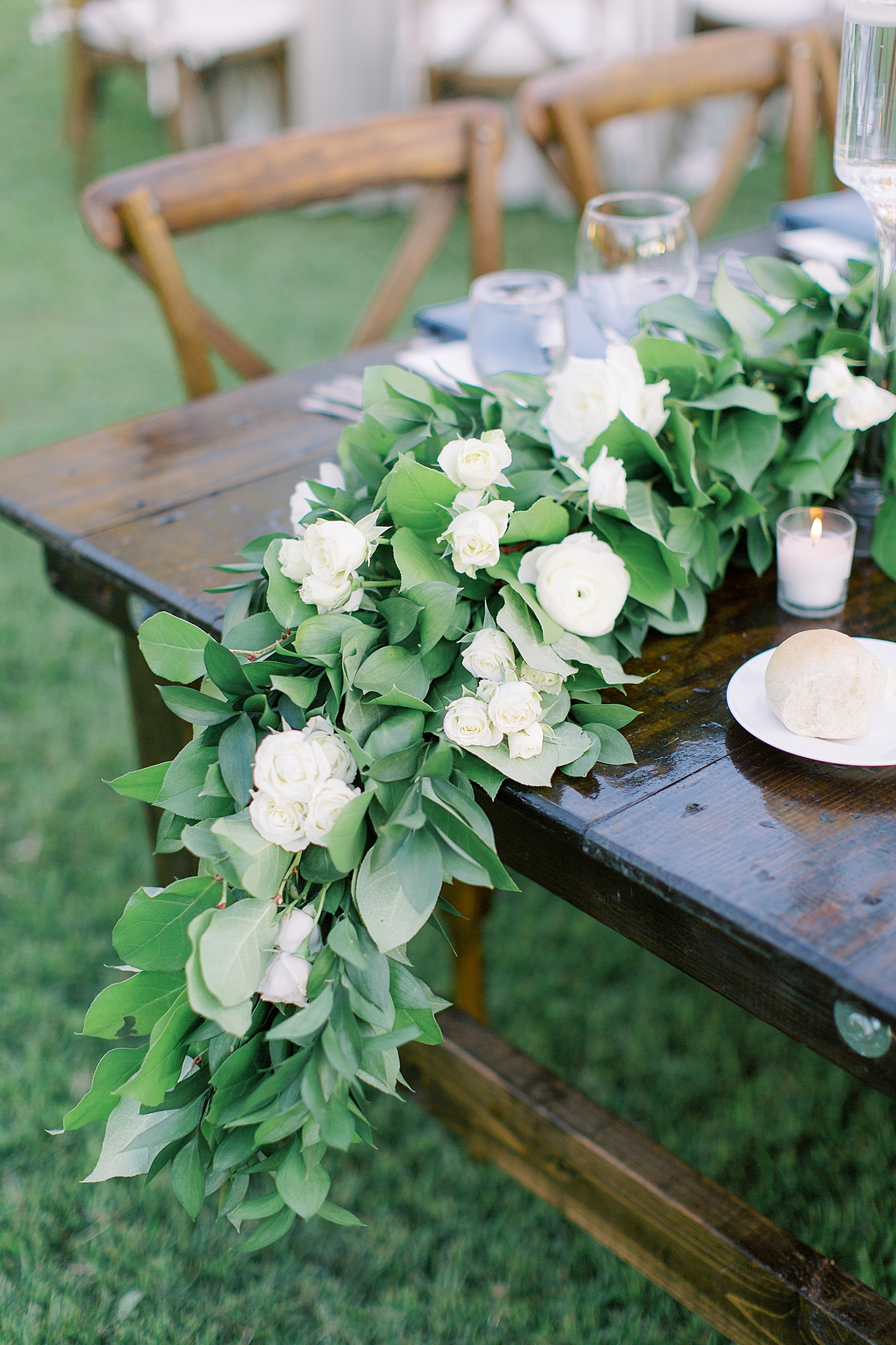 floral drape on dark wood table during rustic wedding reception