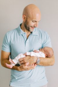 dad holds new baby boy during Charlotte newborn session at home