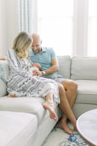 parents look at new baby during lifestyle newborn photos