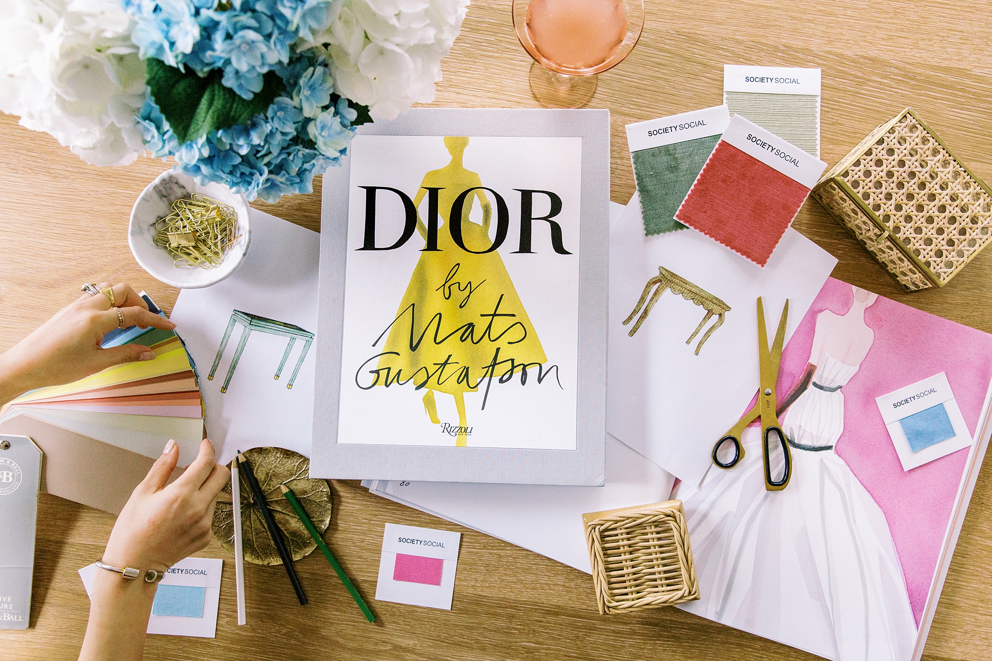 Dior design book lies on swatches of fabric