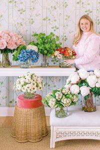 designer arranges flowers for Charlotte product photography session