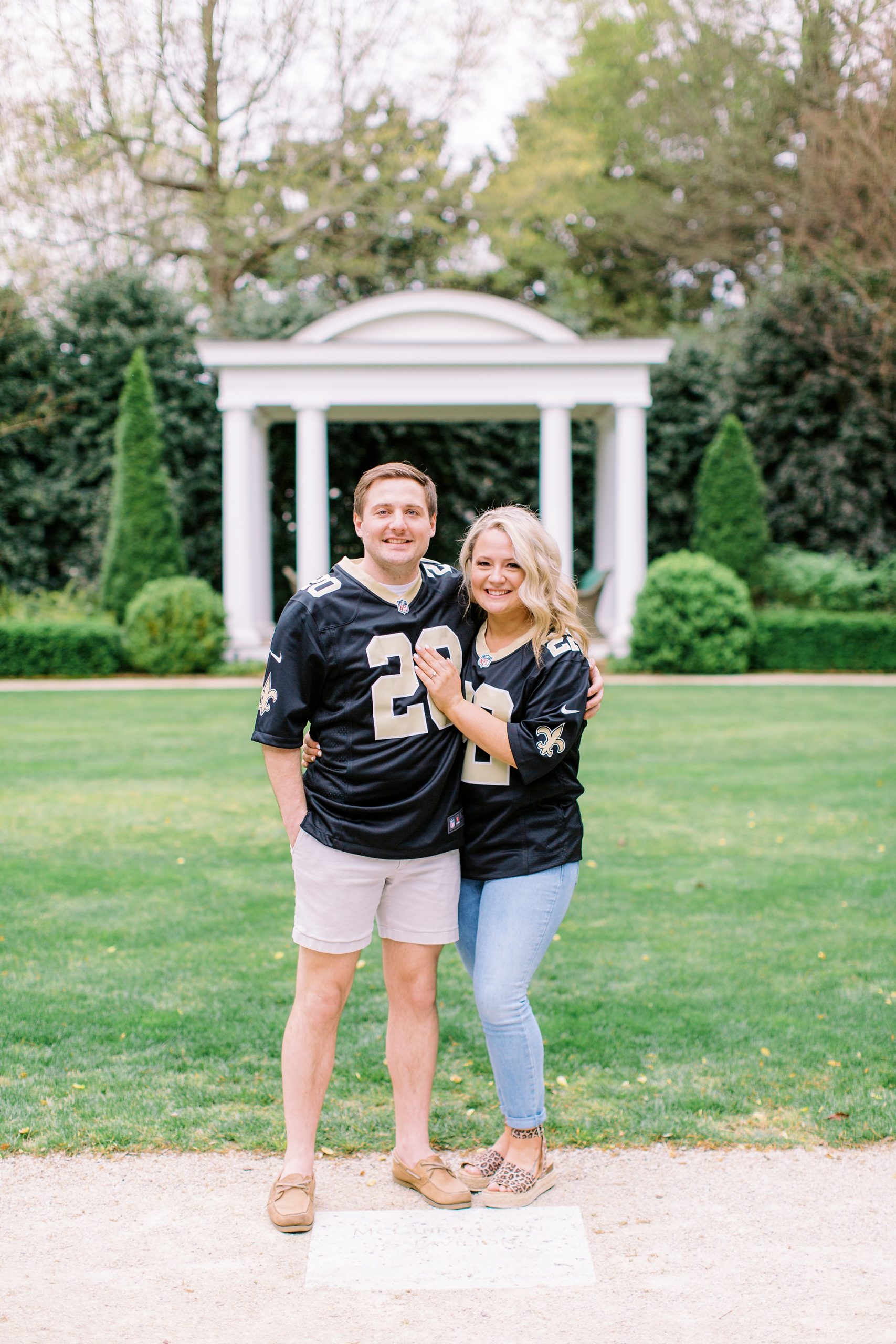 bride and groom pose in gardens during Duke Mansion engagement portraits