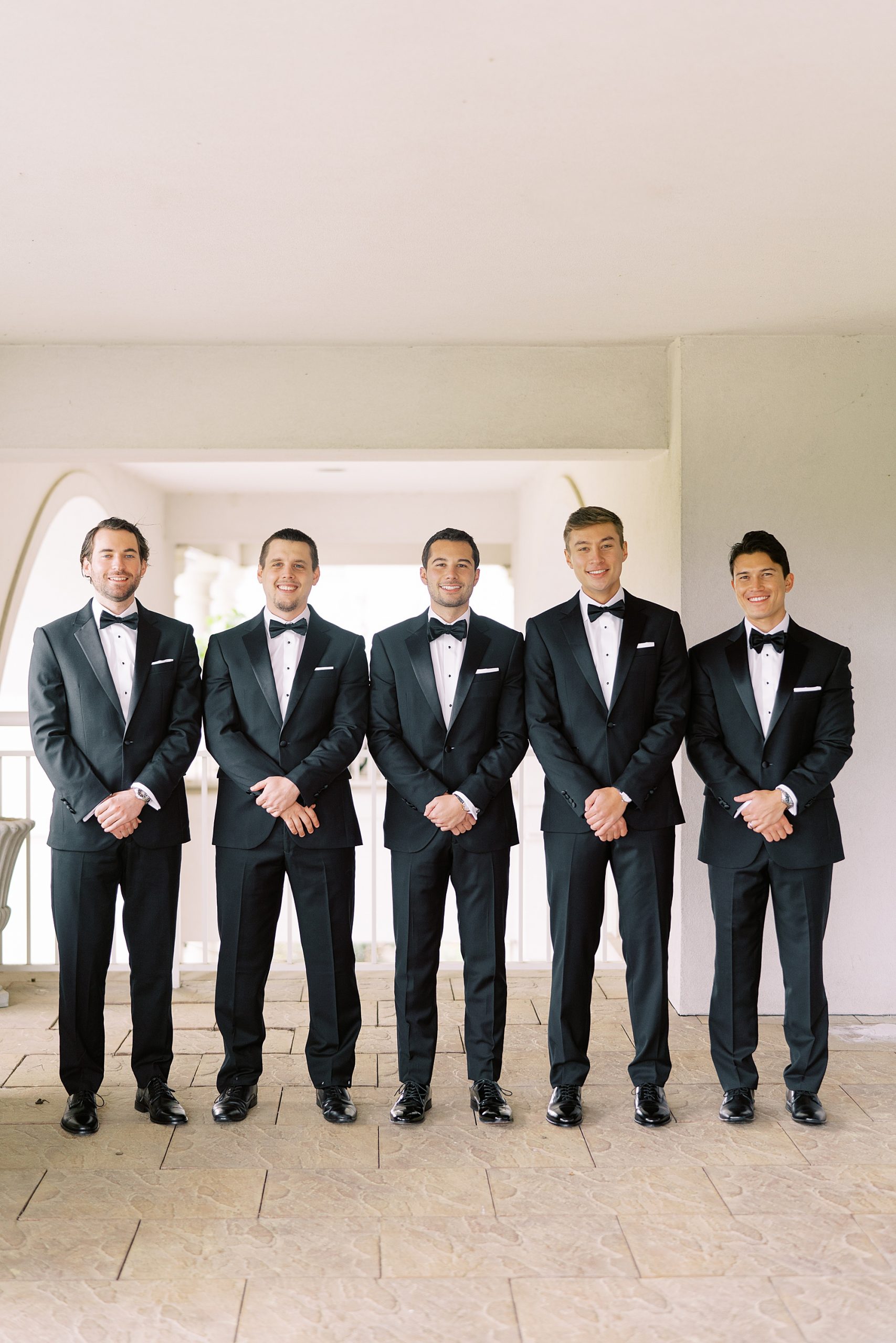 groom poses with four groomsmen at Ballantyne Country Club