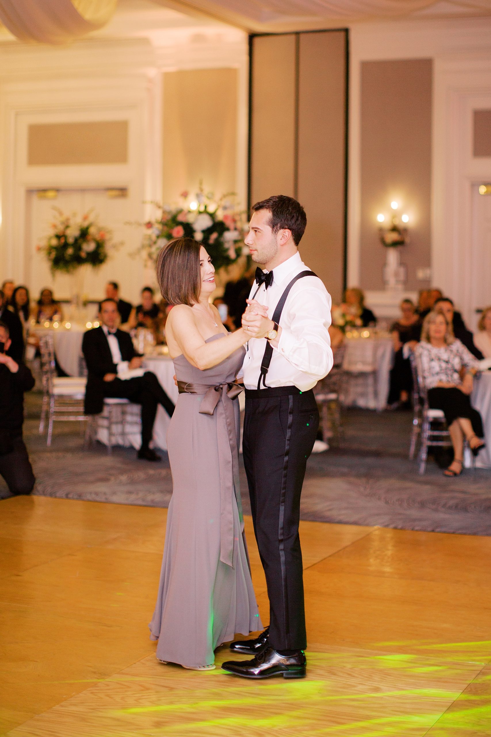 groom and mother dance together during NC wedding reception