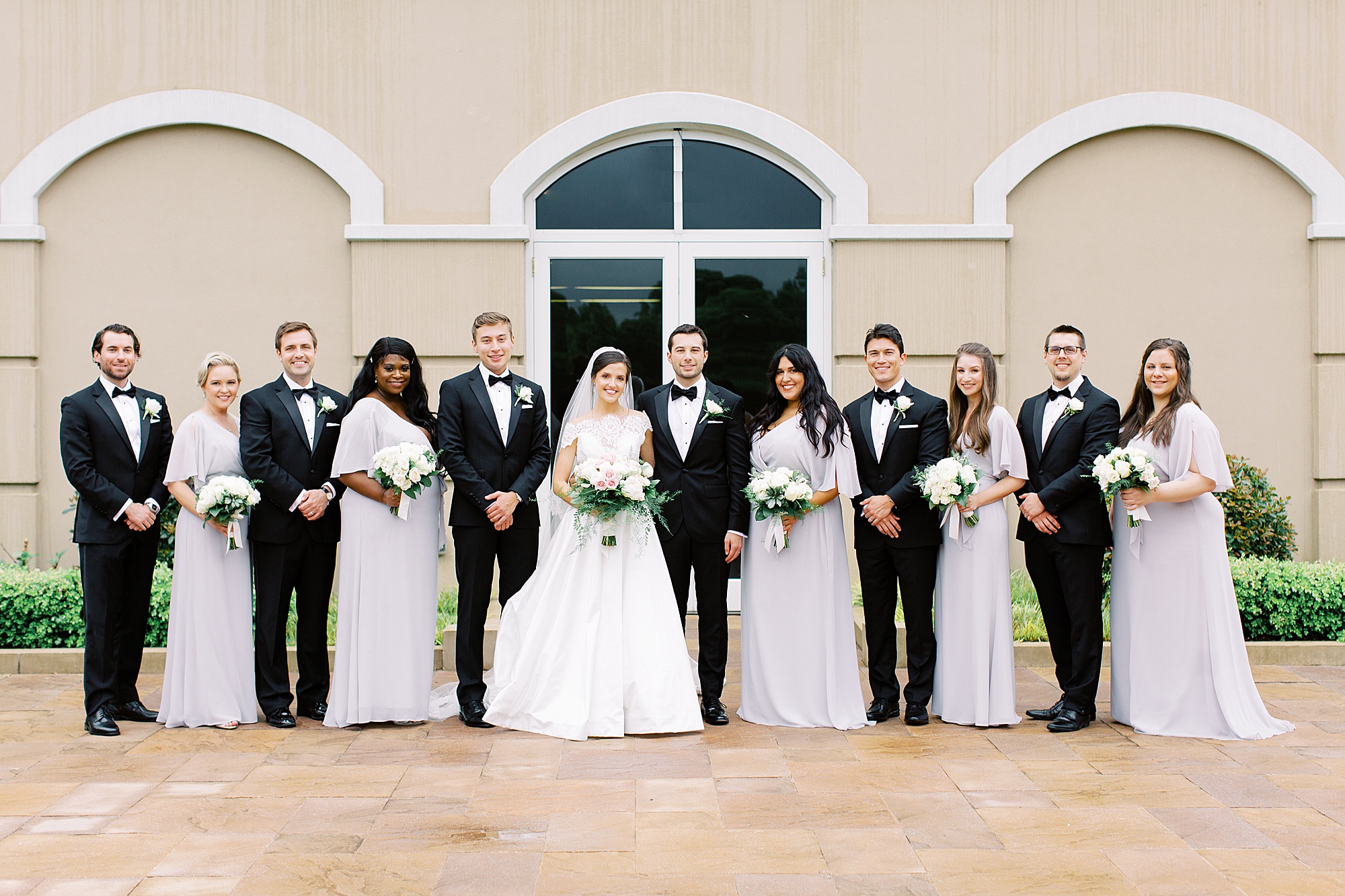 wedding party poses together outside Ballantyne Country Club