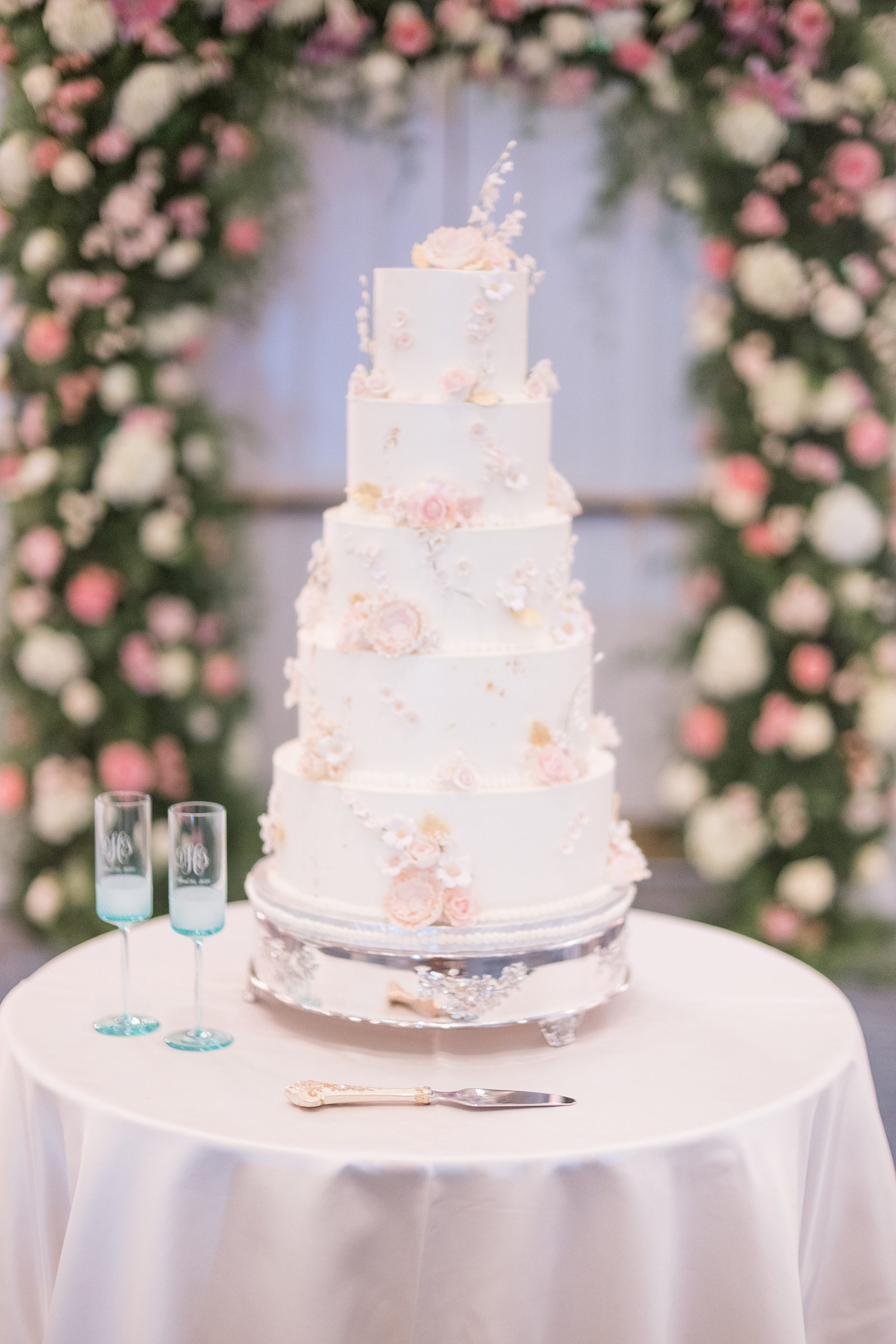 tiered wedding cake with pink floral accents