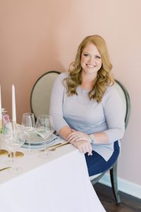 wedding planner sits at table after setting it