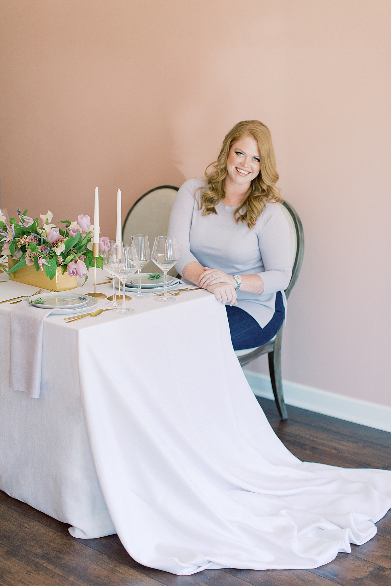 wedding planner sits at table during branding photos with Charlotte branding photographer Demi Mabry