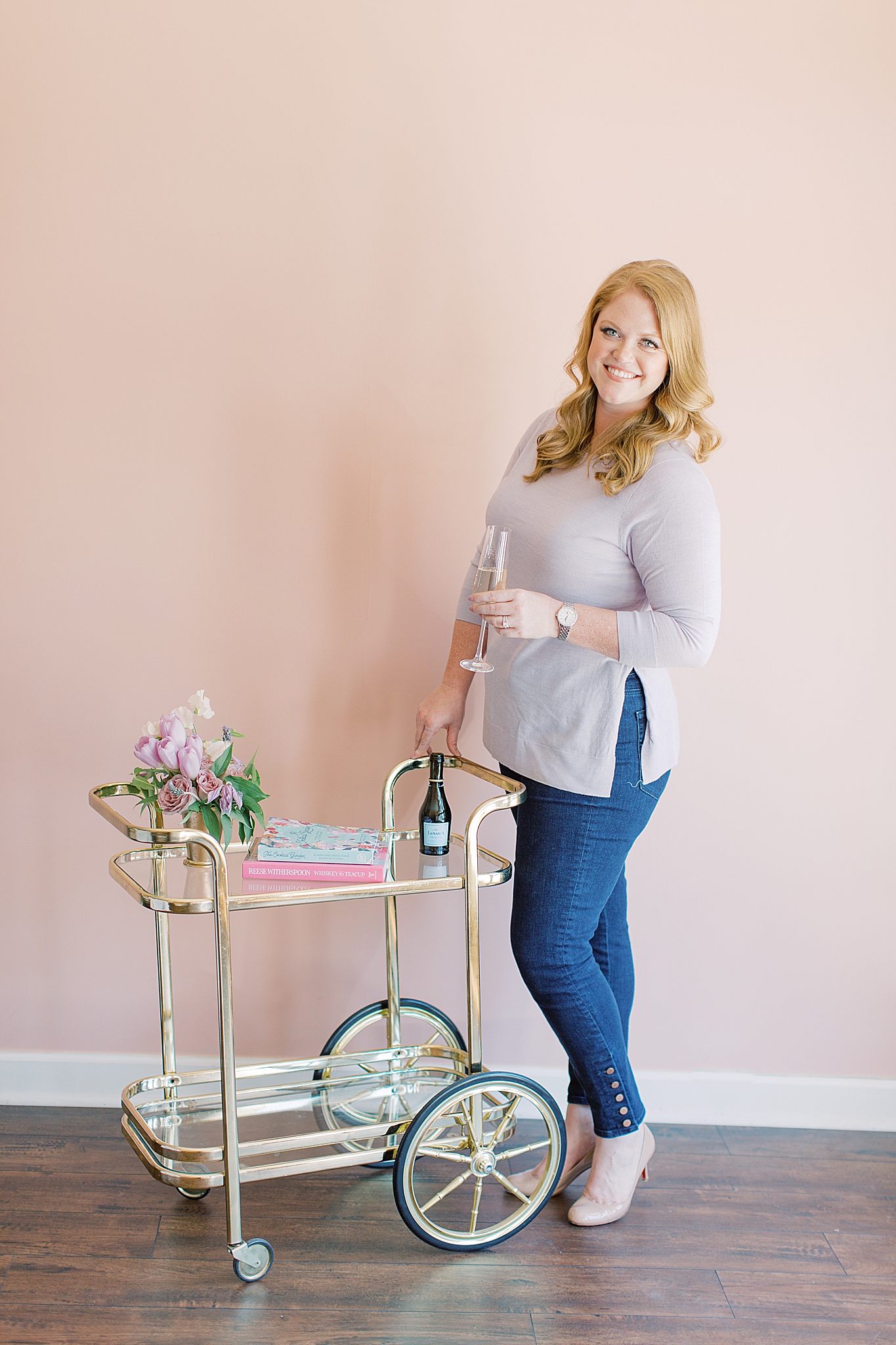 event planner stands with gold drink cart