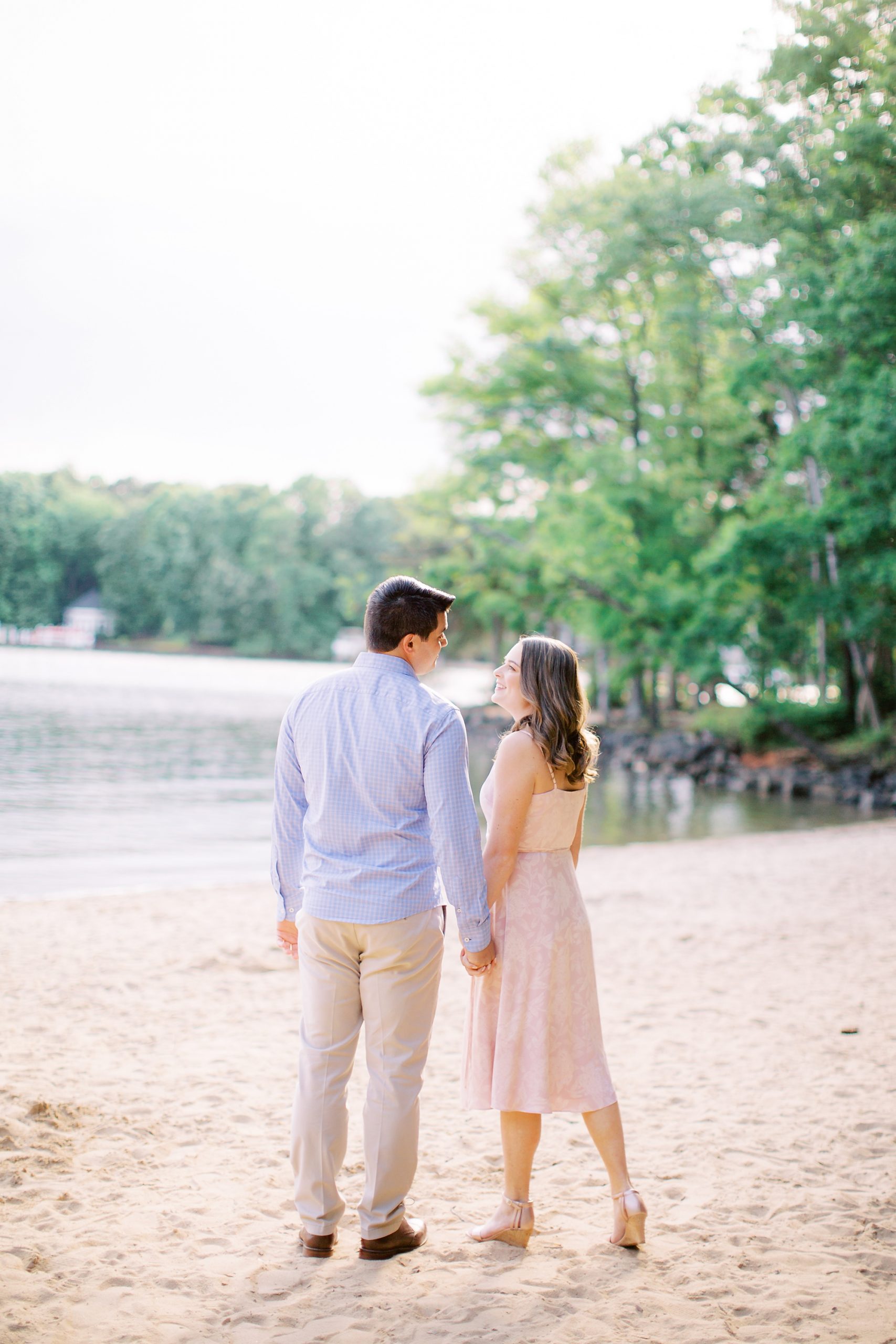 Lake Norman engagement session for couple with pastel outfits