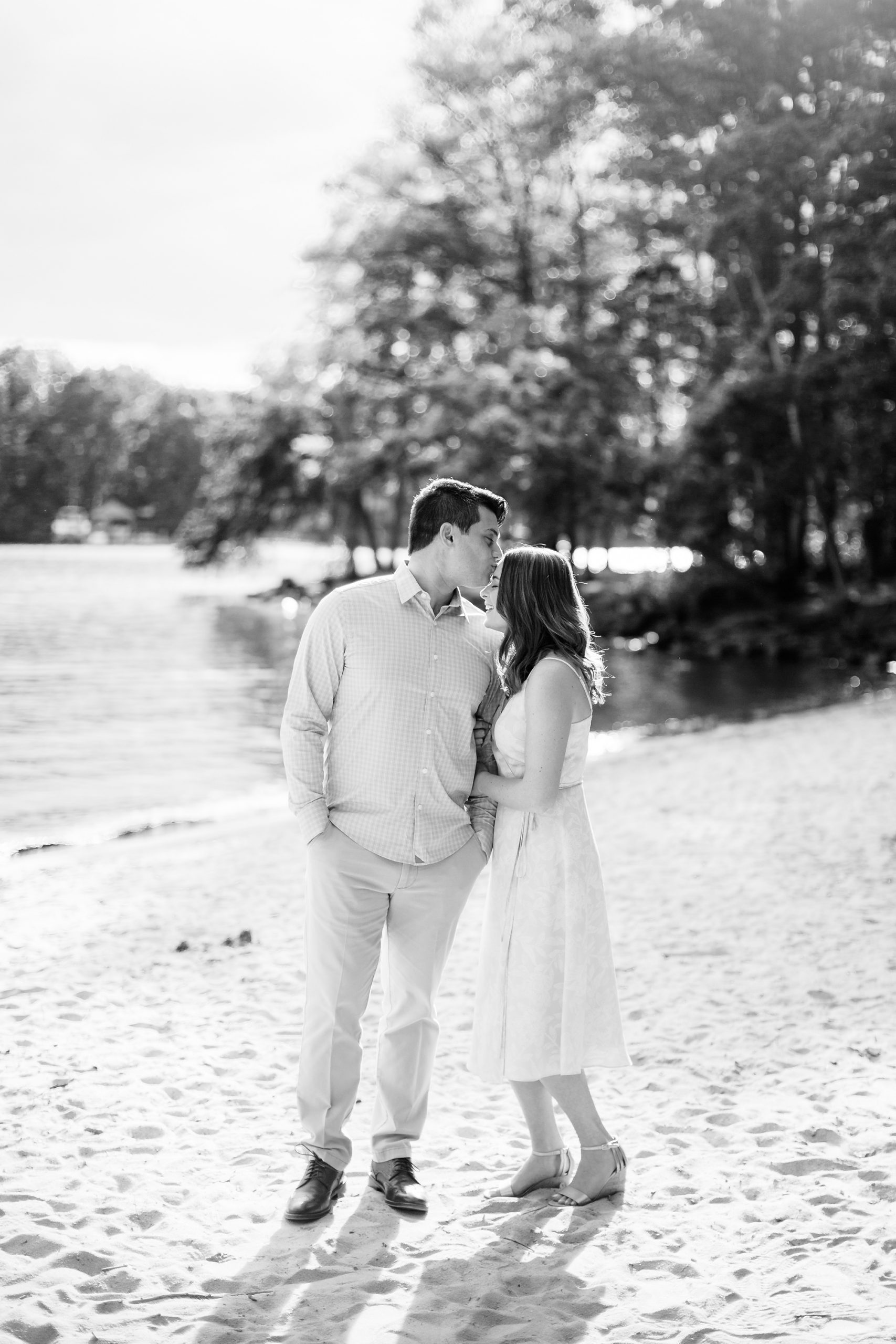 groom kisses bride's forehead during Lake Norman engagement session