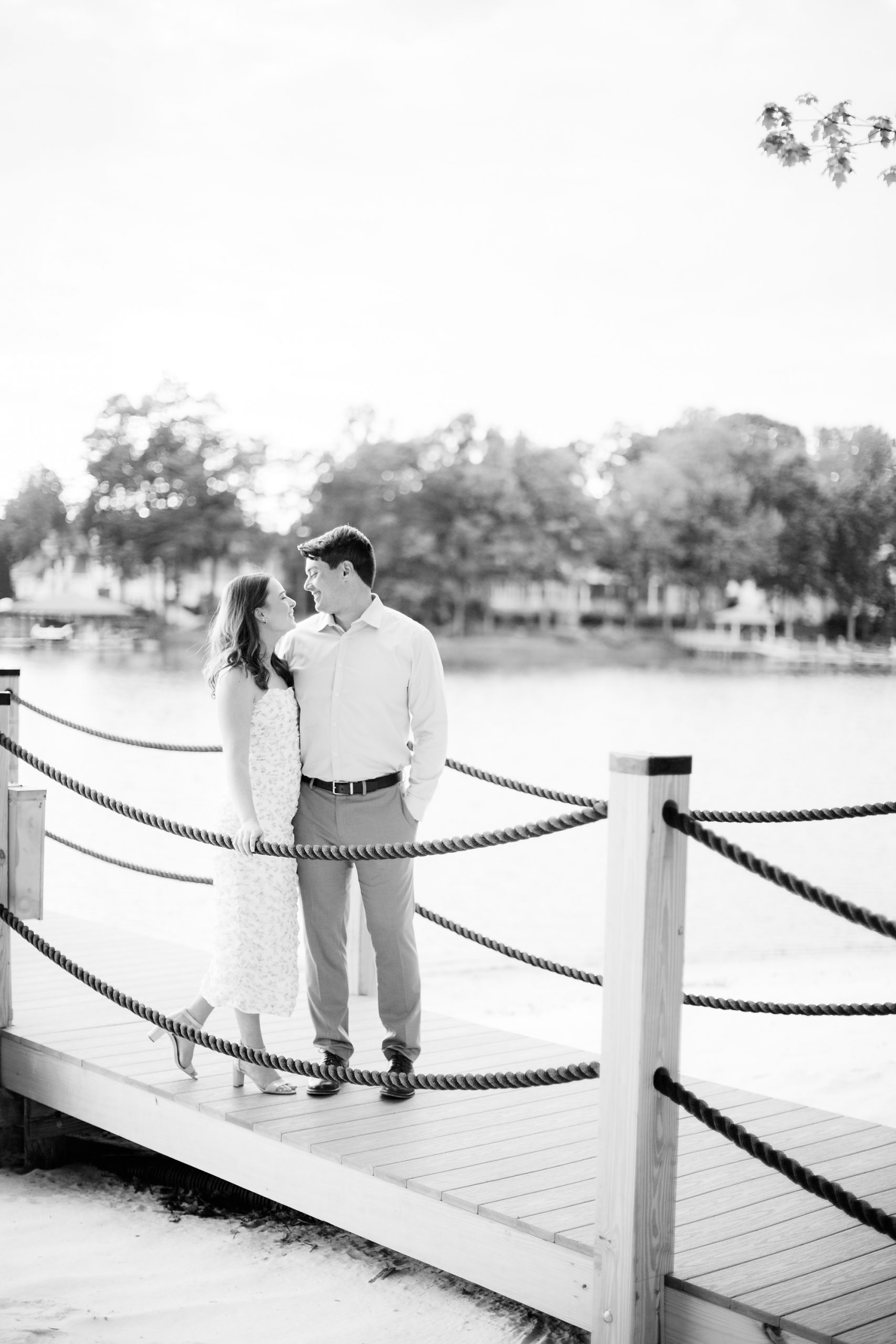 bride and groom walk on dock at Lake Norman