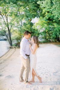 bride and groom stand on beach at Lake Norman