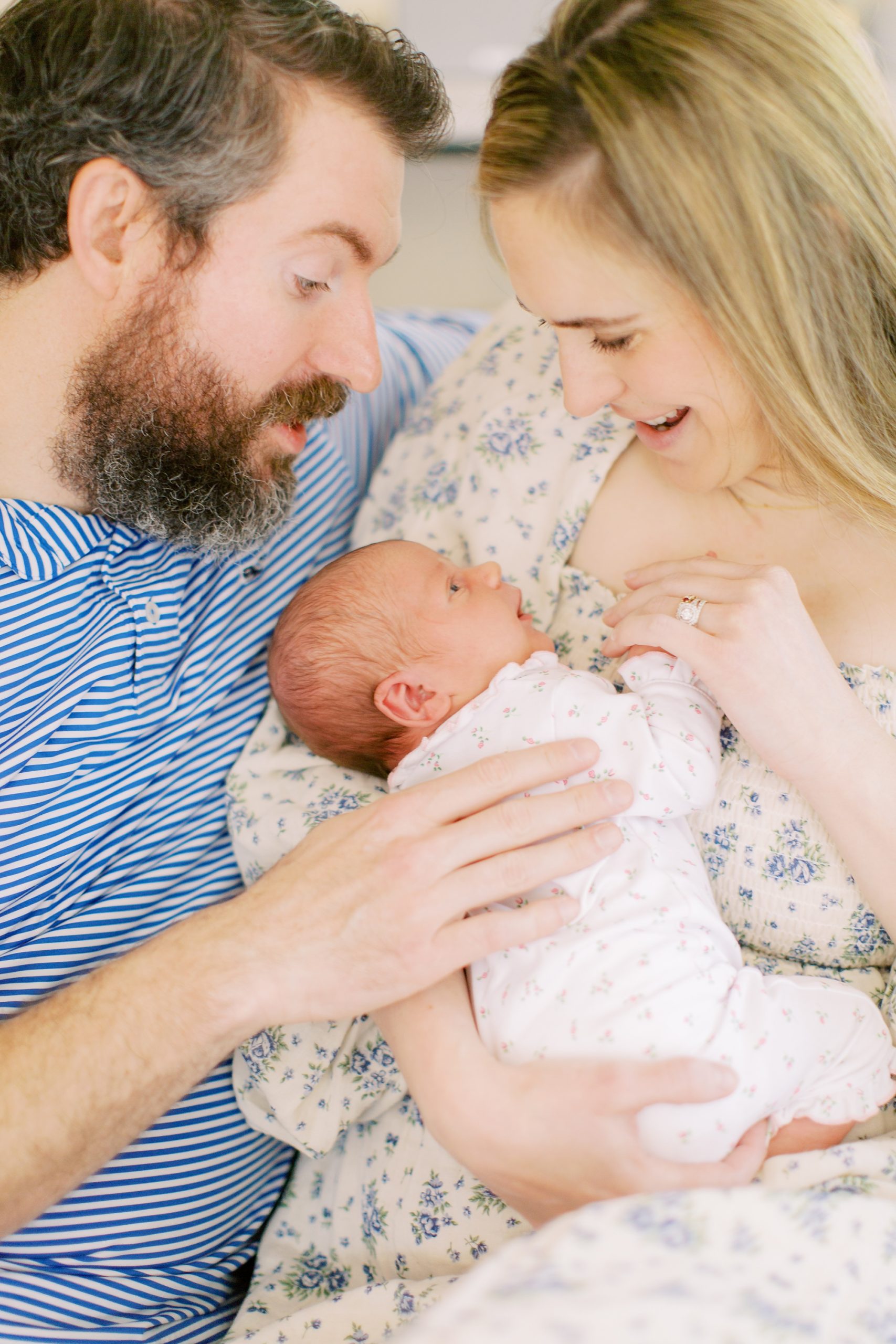 family sits on couch during Charlotte In Home Lifestyle Newborn Session