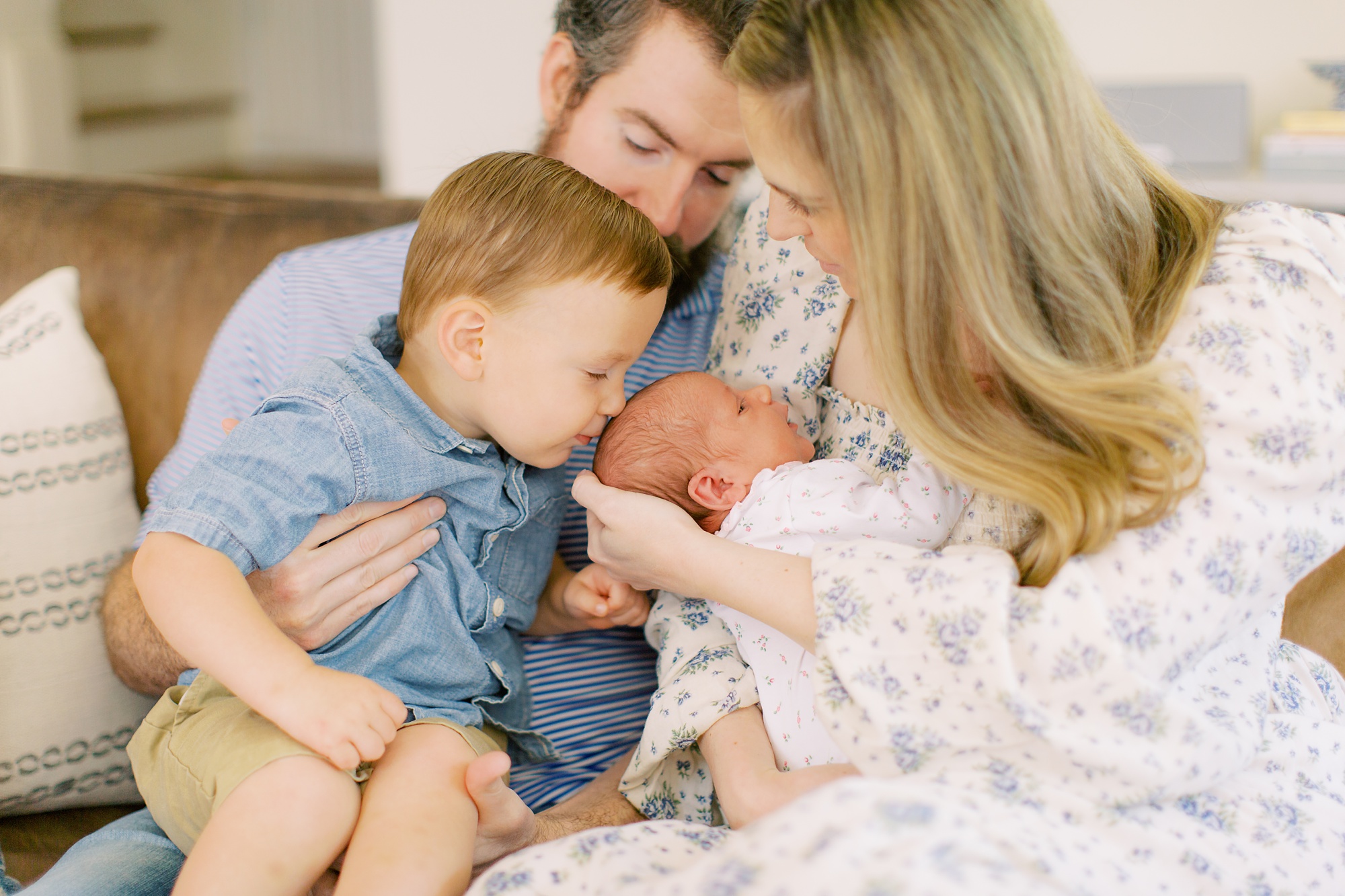big brother kisses new baby sister during lifestyle newborn session
