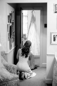 bridesmaid adjusts wedding gown for Charlotte wedding