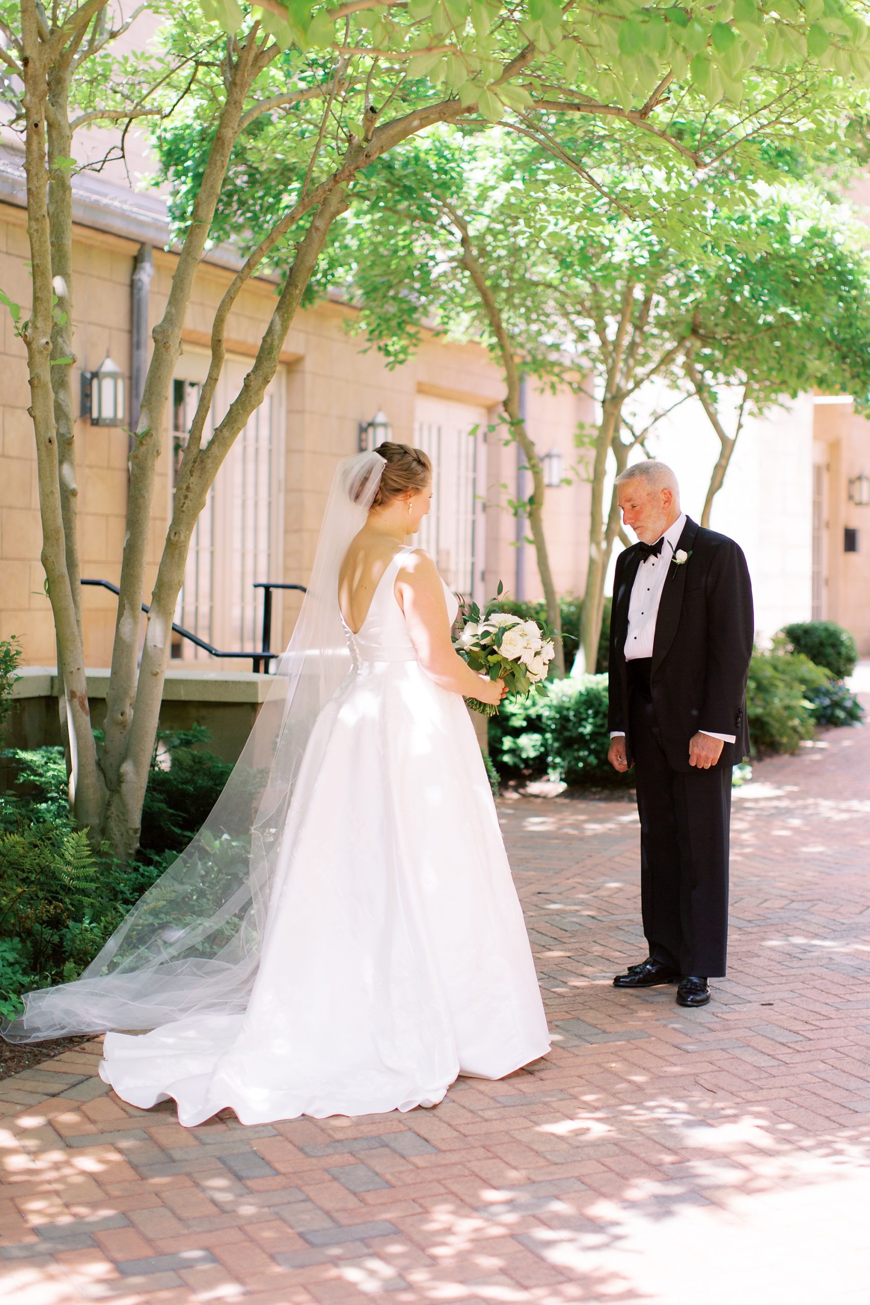 bride and dad have first look before VanLandingham Estate wedding