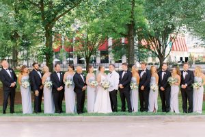 bride and groom pose with wedding party in Charlotte NC