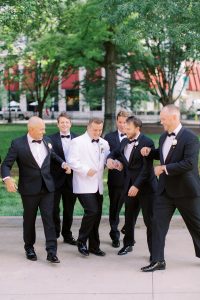 groom and groomsmen joke around during photos in Charlotte park