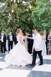 groom twirls bride during VanLandingham Estate wedding dances