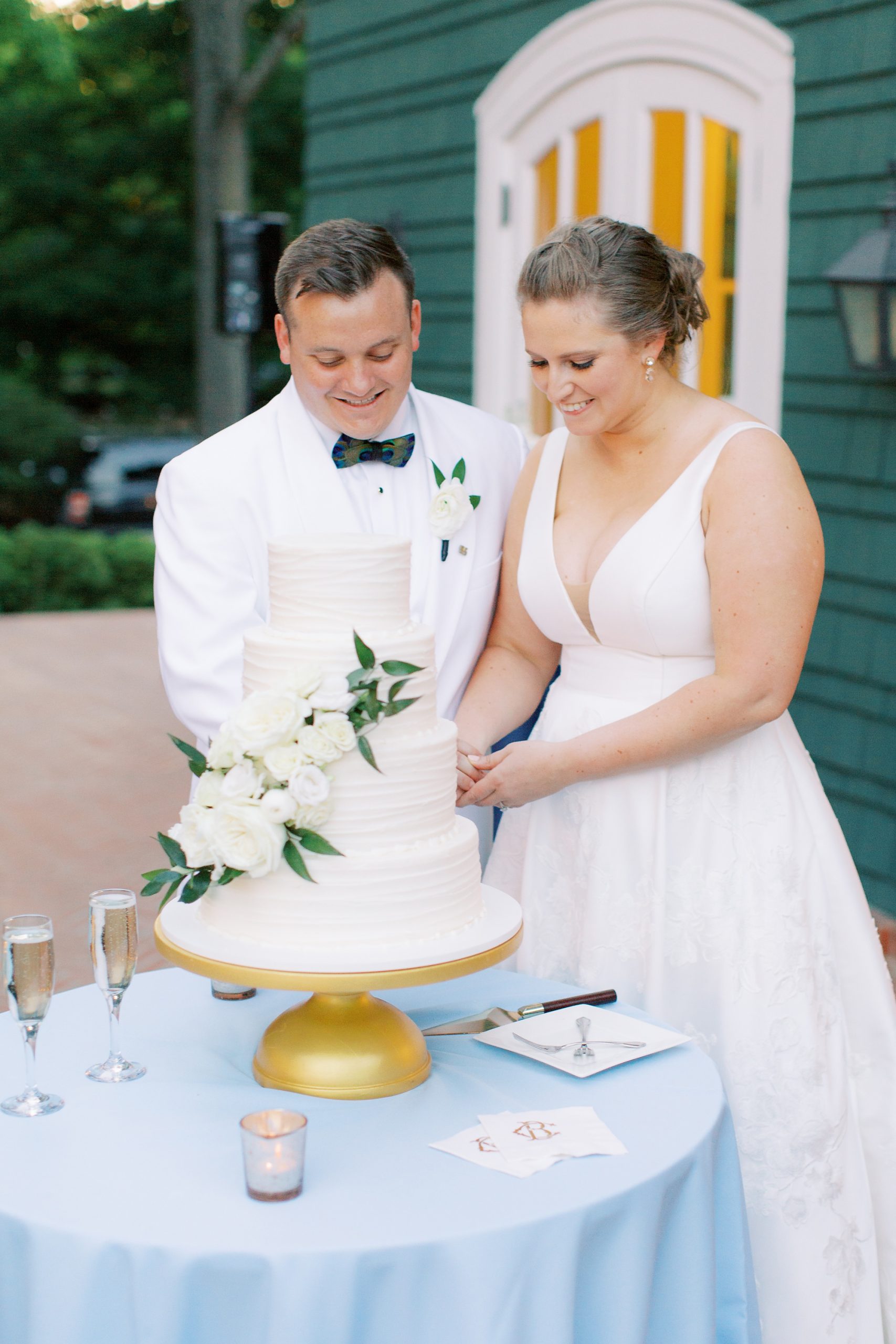 bride and groom cut wedding cake during VanLandingham Estate wedding