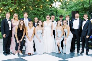 bride and groom pose with guests during VanLandingham Estate wedding reception