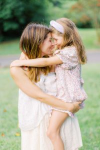 mom holds daughter and touches foreheads together during Charlotte family session