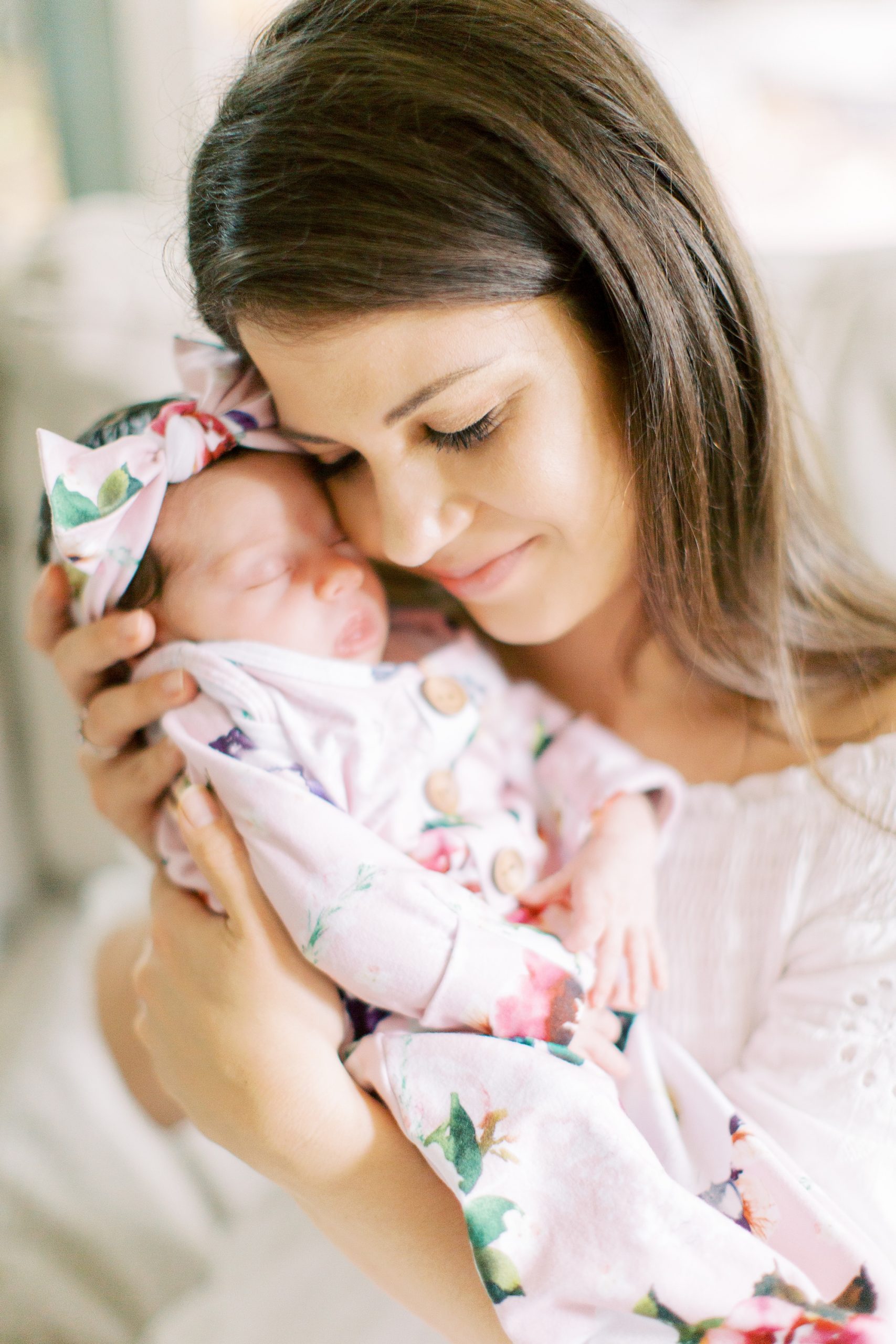 mom snuggles baby girl photographed by Charlotte Newborn Photographer Demi Mabry