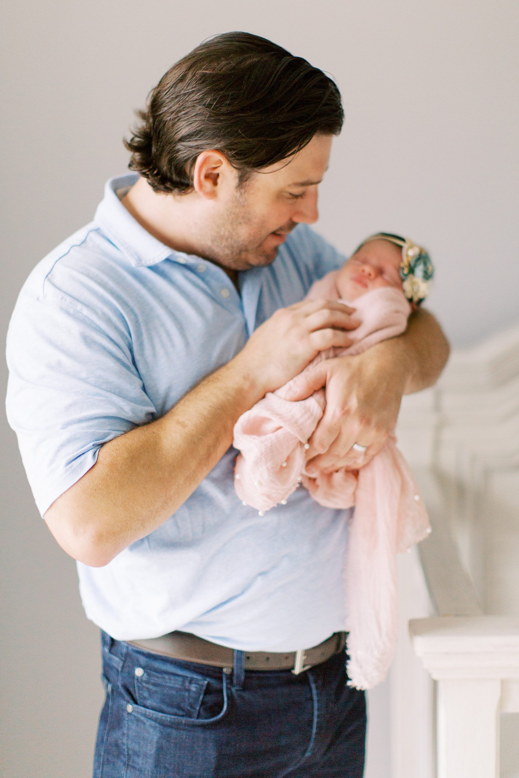 dad and daughter pose in nursery photographed by Charlotte Newborn Photographer Demi Mabry