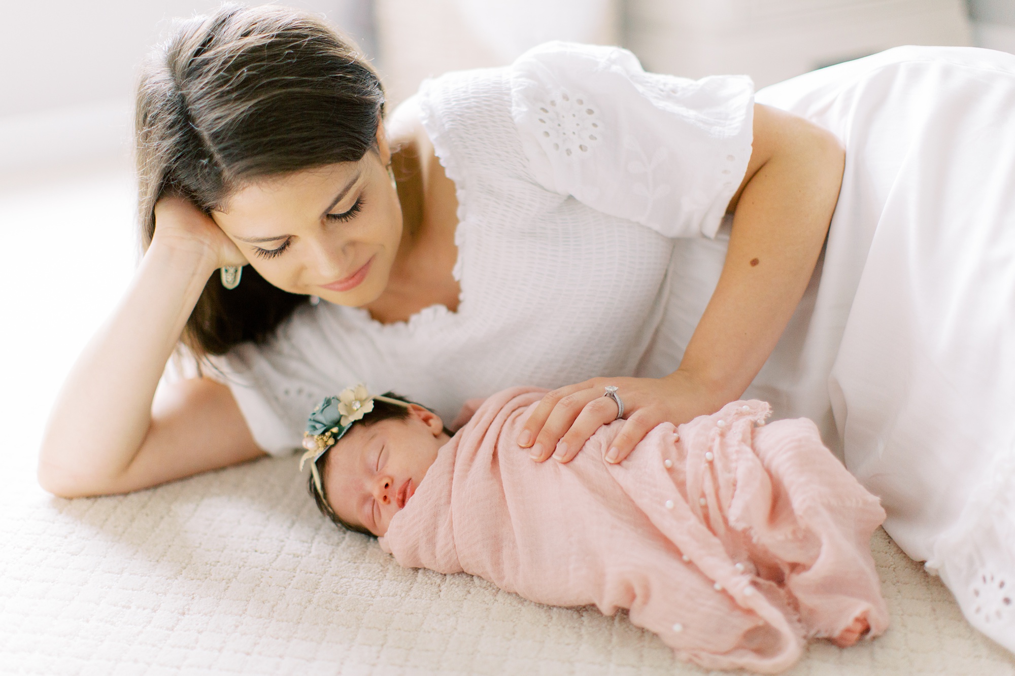 mom looks at daughter during photos with Charlotte Newborn Photographer Demi Mabry