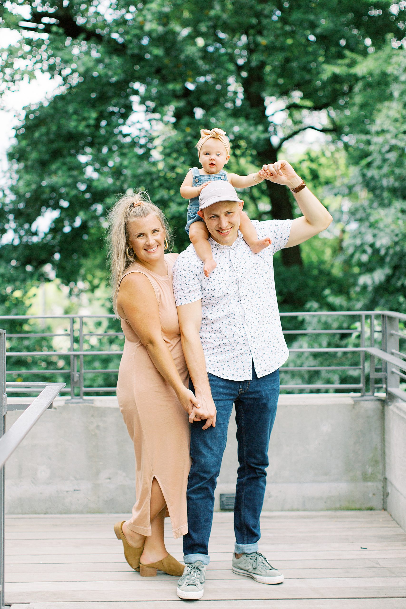 dad holds daughter on shoulders during Ponce City Market family session