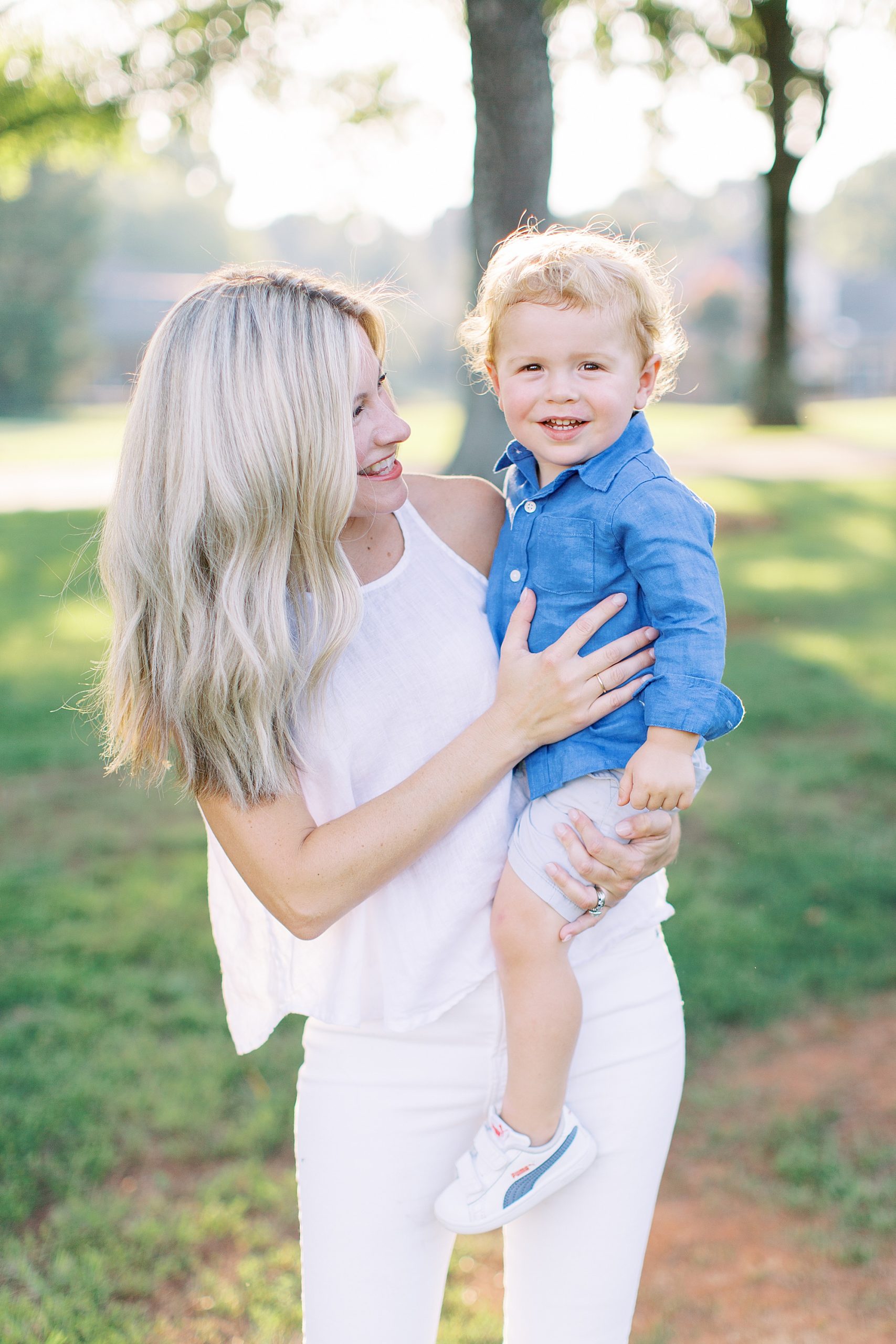 mom hugs son during family photos at Cabarrus Country Club