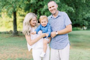 parents pose with son on green of Cabarrus Country Club