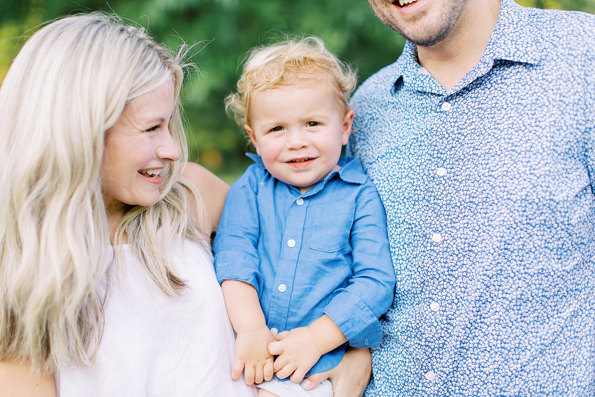mom and dad look at son during Cabarrus Country Club family portraits