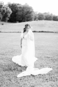 bride looks down at veil during session at The Dairy Barn