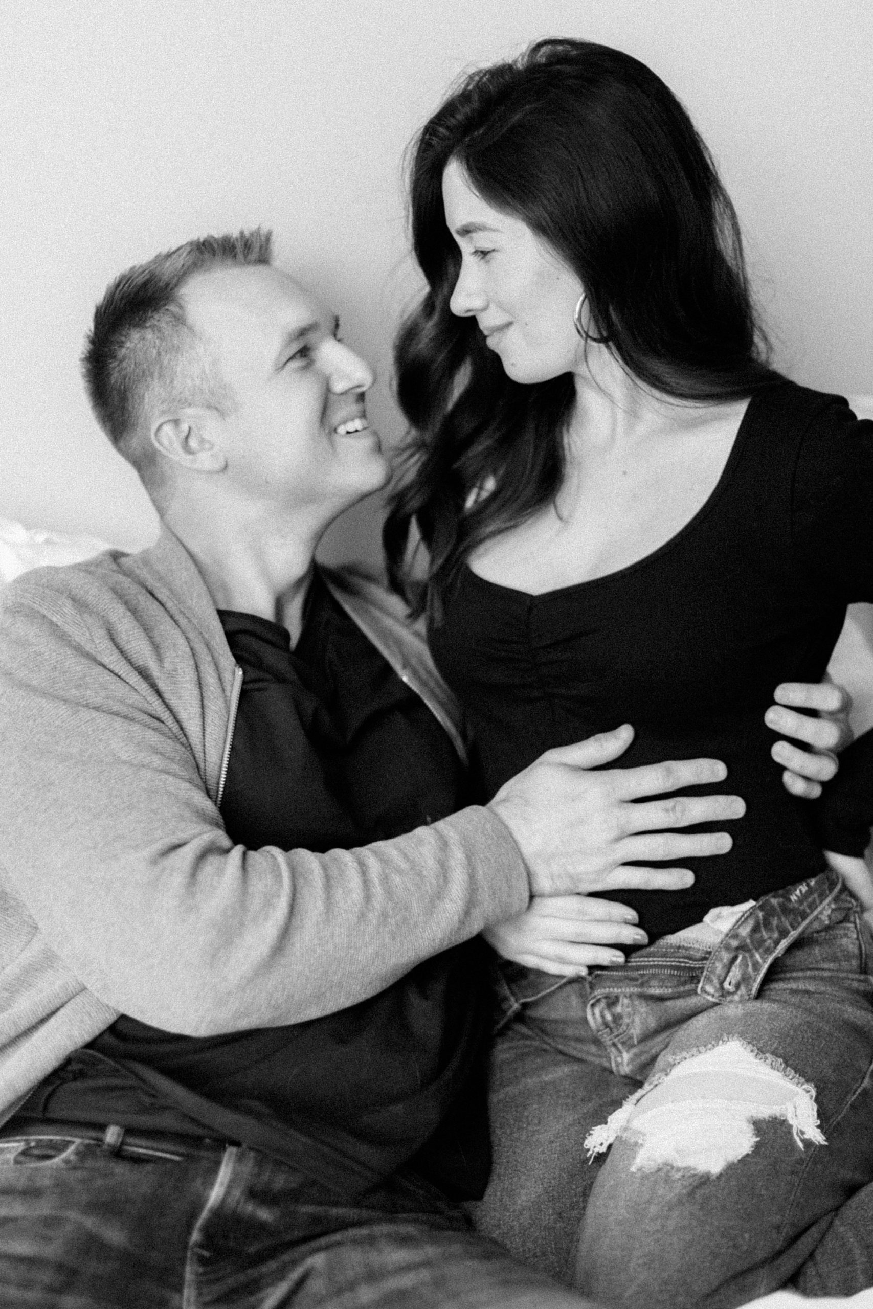 man holds wife during pregnancy announcement