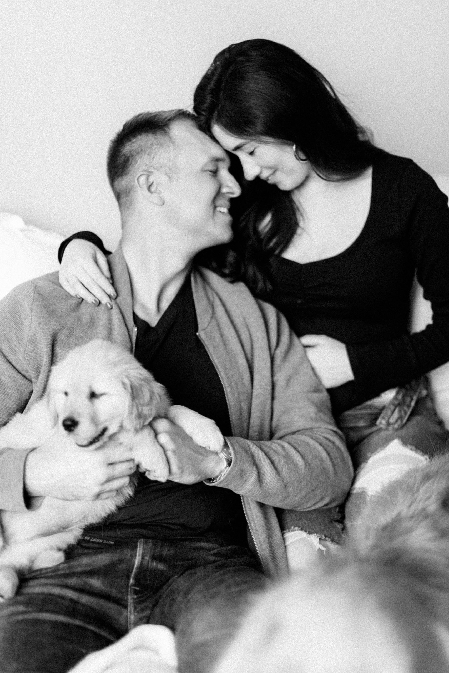 couple sits with new puppy during lifestyle session