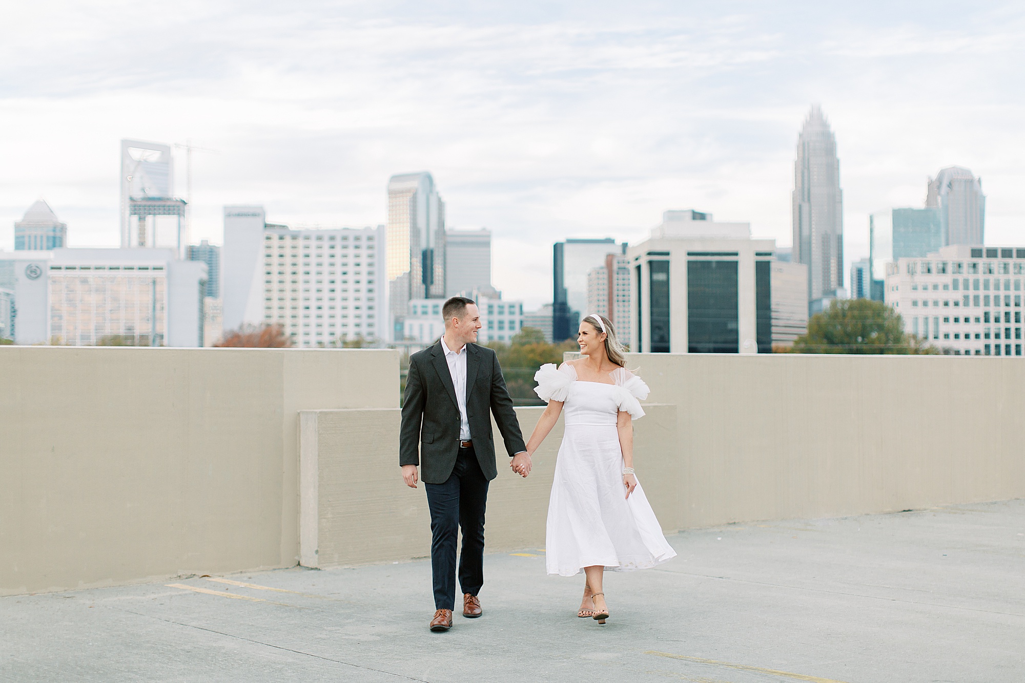 couple walks on rooftop in Charlotte NC