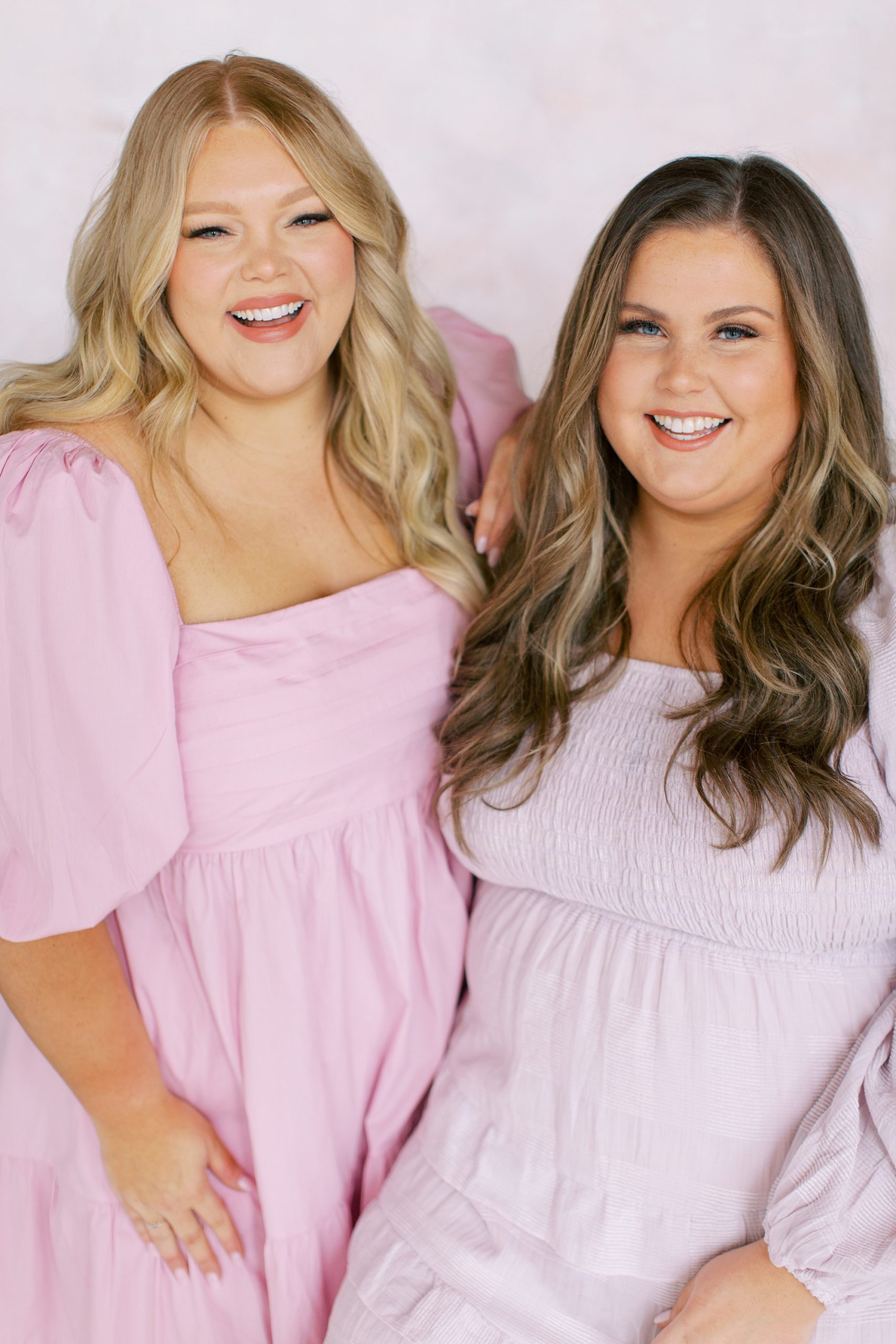 studio branding portrait for two women in pink dresses