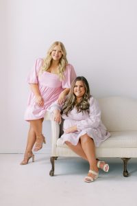 two women pose together on couch during Charlotte NC studio branding portraits