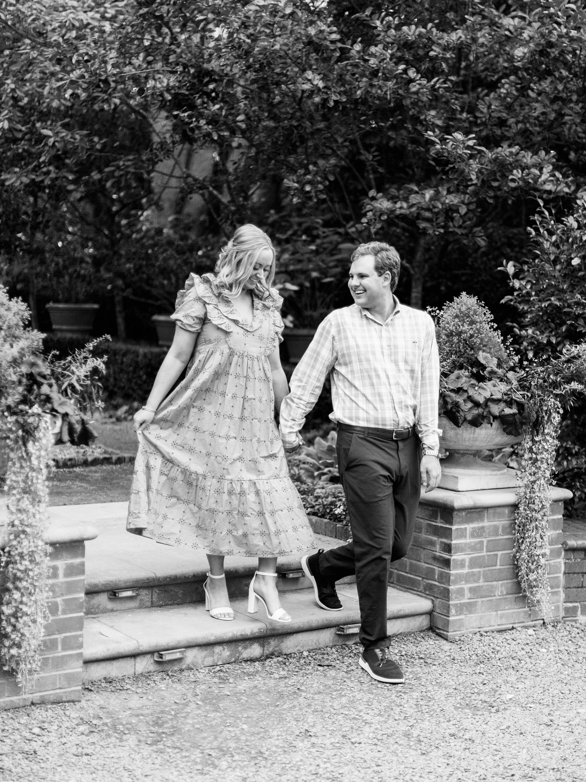 couple walks down steps into gardens at Duke Mansion