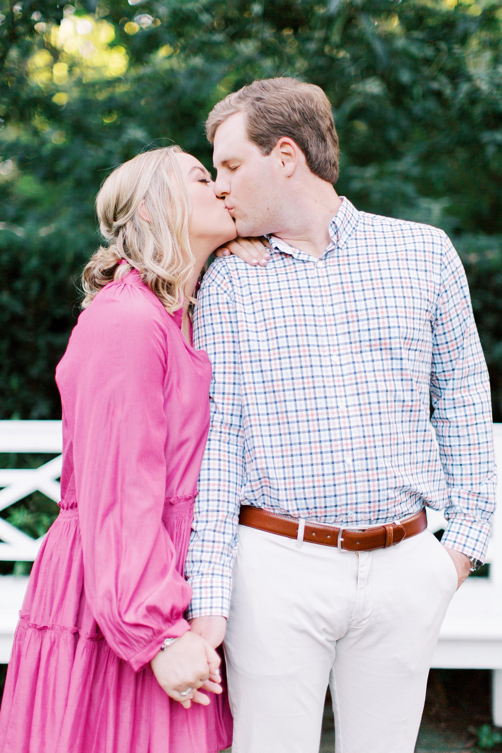 engaged couple kisses during spring engagement session